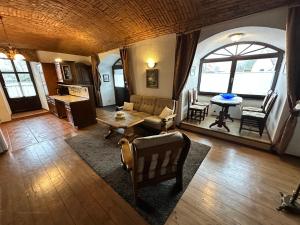 a living room with a couch and a table at Apartmány v Buši in Buš