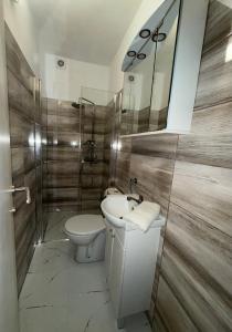 a bathroom with a toilet and a sink and a mirror at Apartment Anka Polače in Polače