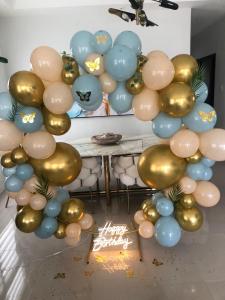 a balloon arch with gold and blue balloons at Great Escape Villa - Ocho Rios in Ocho Rios +18 photos