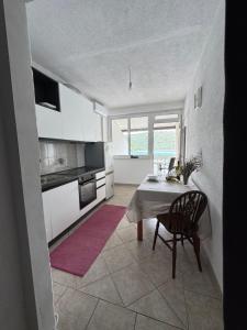 a kitchen with a table and a chair in a room at Apartment Anka Polače in Polače
