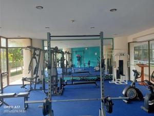 a gym with several tread machines in a room at Vip Condo Rayong beach in Rayong