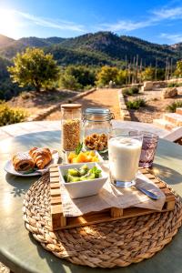 a table with a plate of food and a drink at Ribazos de la Sierra in Carmona +32 photos
