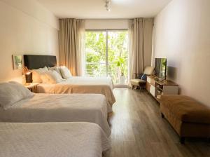 a hotel room with two beds and a window at iDeal Concord Pilar Aparts in Pilar