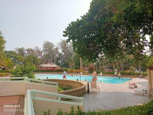a swimming pool with people playing in it at Vip Condo Rayong beach in Rayong