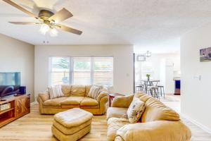 a living room with two couches and a tv at Indy Home w/ Dog-Friendly Yard! 9 Mi to Dtwn in Spring Hollow