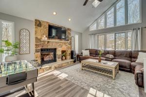 a living room with a couch and a fireplace at Contemporary House in Lakeside Community! Poconos in Albrightsville