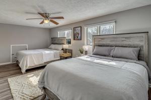 a bedroom with two beds and a ceiling fan at Contemporary House in Lakeside Community! Poconos in Albrightsville +26 photos