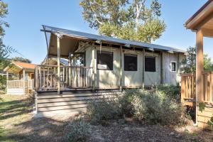 a house with a porch with a roof at Carmel River Inn & Cottages in Carmel