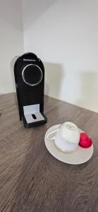 a cell phone sitting next to a plate on a table at Home Lazio 36 in Cosenza