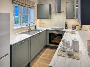 a kitchen with a sink and a counter at Pine View Cottage in Filey