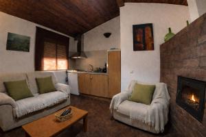 a living room with two couches and a fireplace at Casas Rurales Los Cortijos in Alcaraz