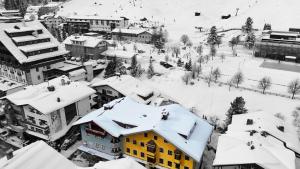 a city with snow covered roofs and buildings at Seeberger Haus B&B in Sankt Anton am Arlberg