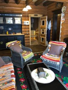 a living room with chairs and a hat on a table at Guta Weekend in Guta