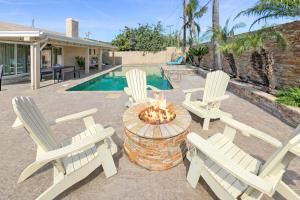 two white chairs and a fire pit in a yard at F-20 Paradise Pier in Anaheim