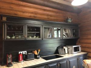 a kitchen with black cabinets and a counter top at Guta Weekend in Guta