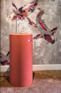 a red container sitting on the floor in front of a wall at Boutique Hotel Lumiere in Eindhoven