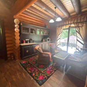 a living room with a couch and chairs in a cabin at Guta Weekend in Guta