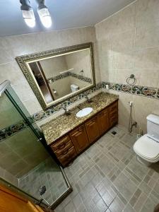 a bathroom with a sink and a mirror and a toilet at Casa Selarón - Lapa centro in Rio de Janeiro +26 photos