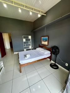 a bedroom with a bed and a fan at Casa Selarón - Lapa centro in Rio de Janeiro