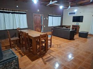 a dining room with a table and a couch at San Antonio Casa Quinta in Banda Florida