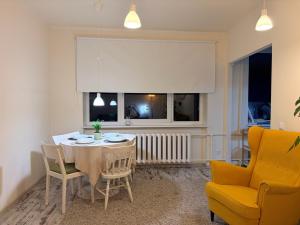 a dining room with a table and chairs and a window at Nice apartment close to the beach in Tallinn