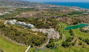 an aerial view of a resort with a lake at Piso en la Costa del Sol by BRISAMAR Holidays in Vélez-Málaga