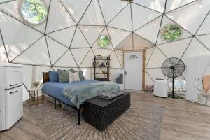a bedroom in a dome tent with a bed at Campfire Hollow in Eagle Rock