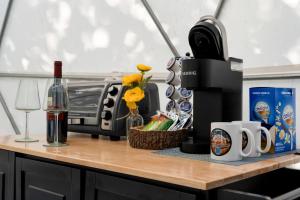 a counter with a coffee maker and a bottle of wine at Campfire Hollow in Eagle Rock