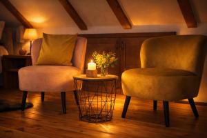 two chairs and a candle on a table in a room at Adria Nord Chalets in Žabljak