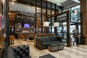 a lobby with a couch and a bar at Archer Hotel New York in New York