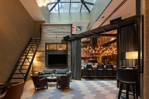 a lobby with a couch and a bar at Archer Hotel New York in New York