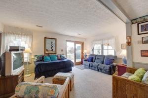 a living room with a couch and a tv at AV67 Diamond Shoals 67 in Avon