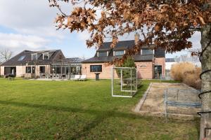 a house with a soccer goal in the yard at Vakantiehoeve Breathe Nature in Lochristi