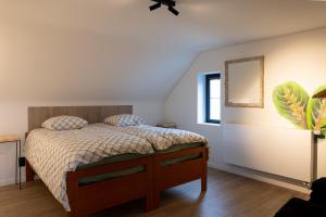 a bedroom with a bed and a mirror on the wall at Vakantiehoeve Breathe Nature in Lochristi