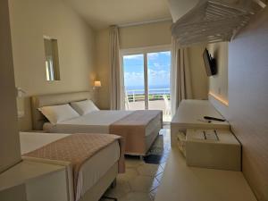 a hotel room with two beds and a balcony at Borgo San Cosmo Tropea in Brattirò +124 photos