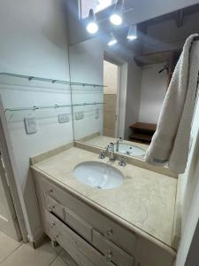 a bathroom with a sink and a mirror at Alojamiento en el centro de Salta - Casaguemessalta in Salta