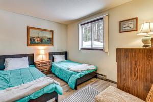 a bedroom with two beds and a window at 3 Mi to Windham Mountain: Pet-Friendly Apt w/ Yard in Hensonville