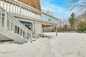 a house with snow on the ground in front of it at 3 Mi to Windham Mountain: Pet-Friendly Apt w/ Yard in Hensonville