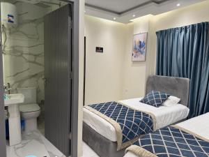 a small bedroom with a bed and a bathroom at Colour holiday Zayed in Sheikh Zayed