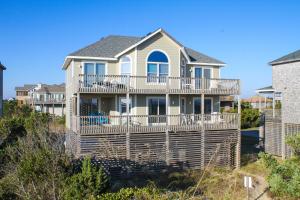 a house with a large deck on a beach at AVK7 Poetry in Motion #7-K in Avon