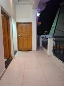 a hallway with a wooden door on a building at Vatika palace in Ayodhya +4 photos