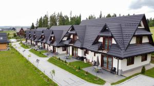 an overhead view of a house with a black roof at Domki Pod Lasem Podhale in Zakopane