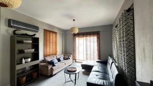 a living room with a couch and a table at Citrus Stone House in Koycegiz
