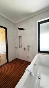 a bathroom with a bath tub and a window at Citrus Stone House in Koycegiz +19 photos