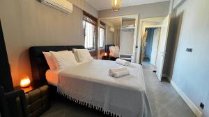 a bedroom with a large bed with two towels on it at Citrus Stone House in Koycegiz