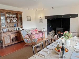 a living room with a table and a fireplace at Brightworthy Farm Withypool in Withypool