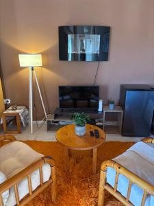 a living room with two beds and a table at Aegean Window - Sea View Studio in Salamina