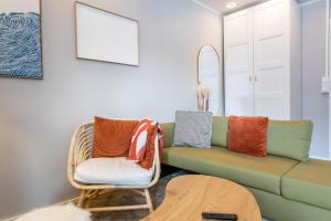a living room with a couch and a chair at Coastal Wooden Apartment Rauma in Rauma