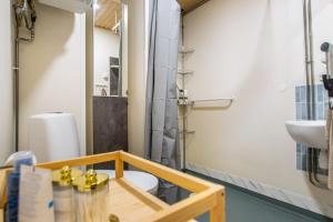 a bathroom with a shower and a toilet and a sink at Coastal Wooden Apartment Rauma in Rauma +7 photos