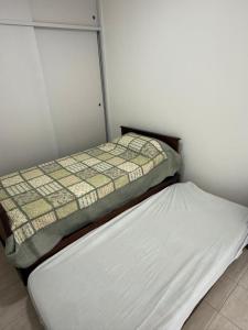 two beds sitting next to each other in a room at Departamento Plumerillo in Santa Rosa
